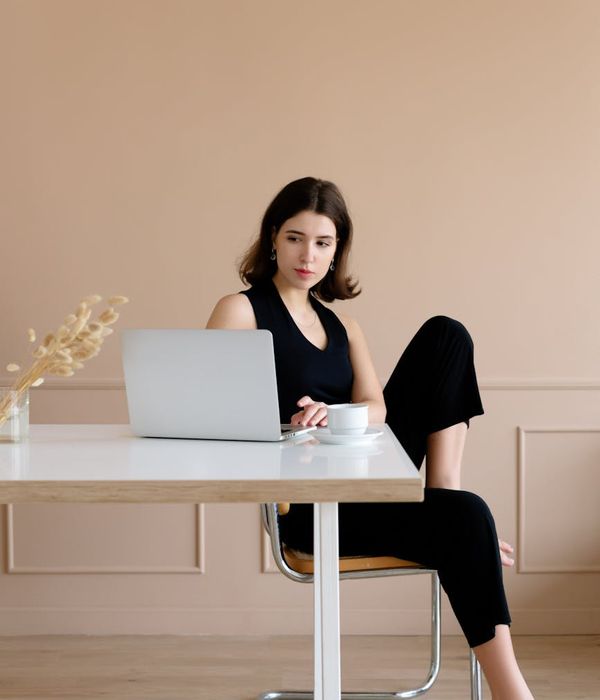 Person looking calm and focused while working on a laptop.